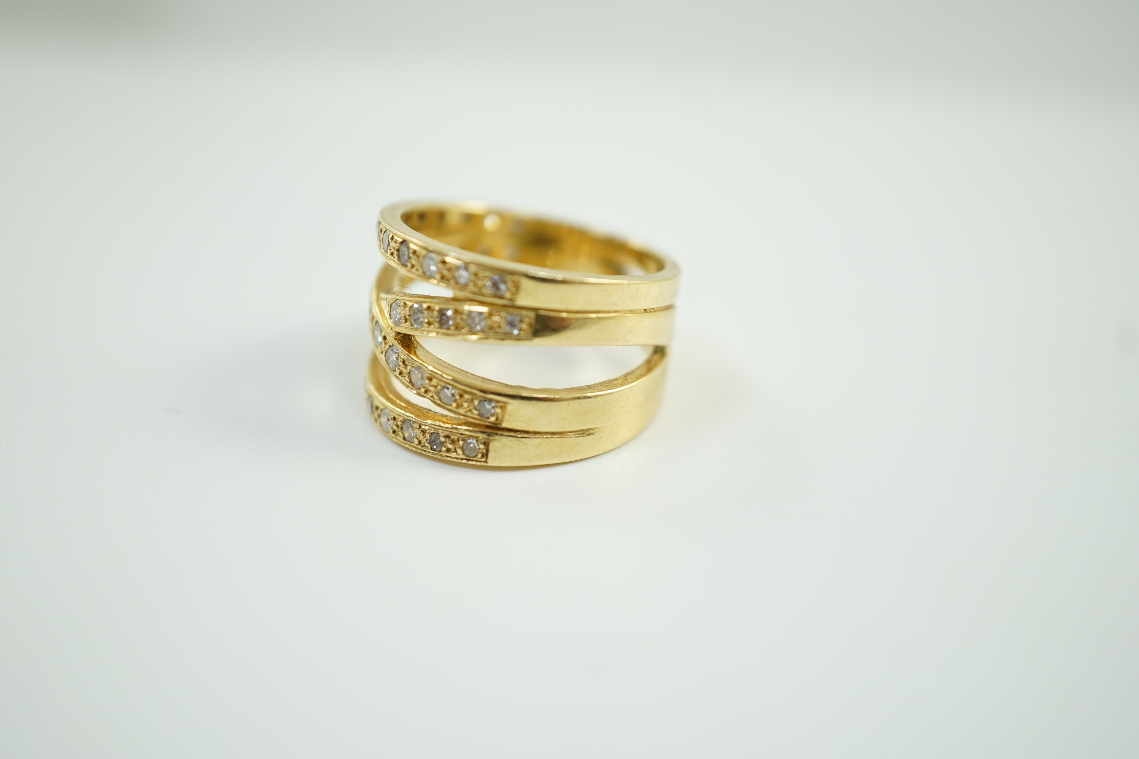 A modern 750 and diamond chip cluster set multi shank dress ring, size P, gross 10.1 grams.